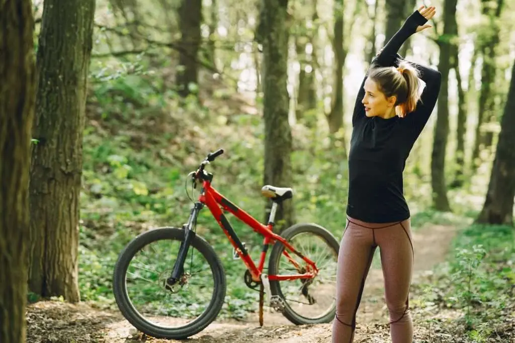 Woman riding a mountain bike in the forest